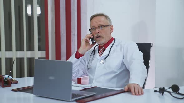 doctor talking on the phone in the office alt