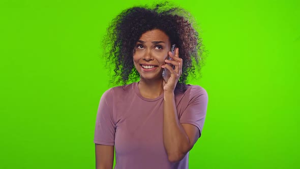 Young Emotional African American Woman Talks on Phone and Dances on Chromakey alt
