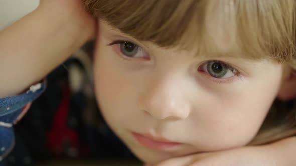 Portrait of a Cute Little Girl Watching TV Intently