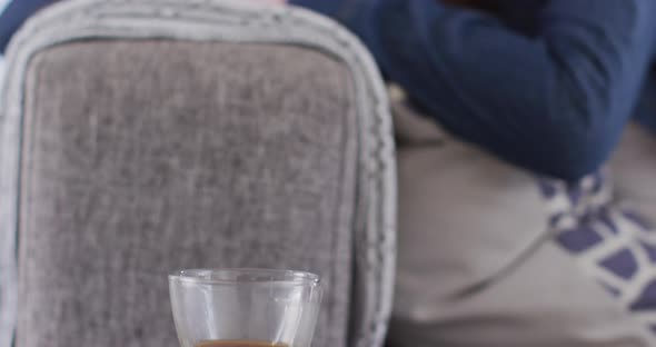 Close up view of woman lying on the couch at home alt