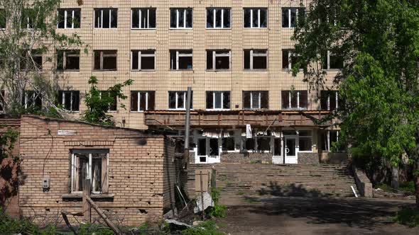 Panning Right to Left of Ruined Building in Kyiv Ukraine with Cars Passing Riding at Front on Road alt