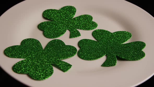 Rotating stock footage shot of St Patty's Day clovers on a white surface - ST PATTYS 007 alt