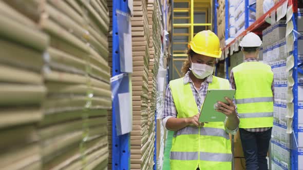 Group of diversity worker wear safety helmet and mask working in warehouse during covid19 pandemic. alt