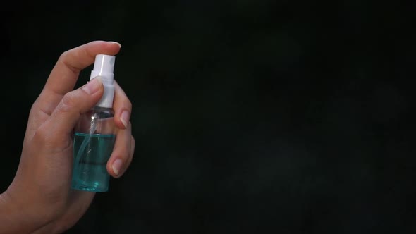 slow-motion of hand using alcohol spray alt