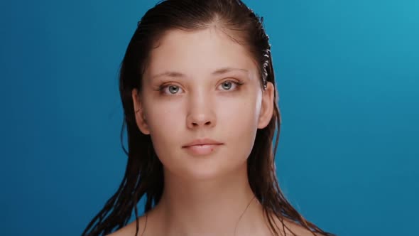 Pretty Cute Girl with Fresh Clean Face and Wet Hair Playing with Eyes and Smiling alt