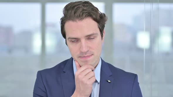 Portrait of Thoughtful Young Businessman Thinking alt