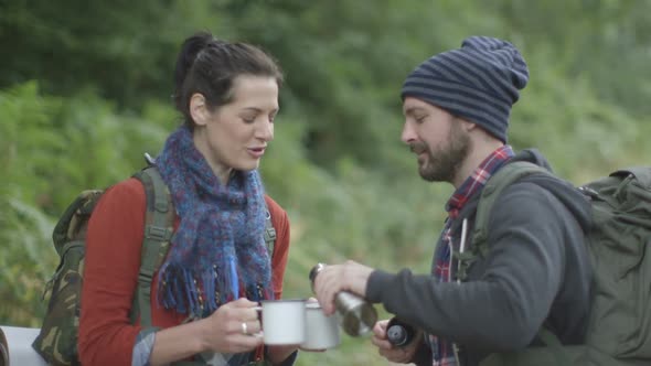 Couple drinking water in forest area