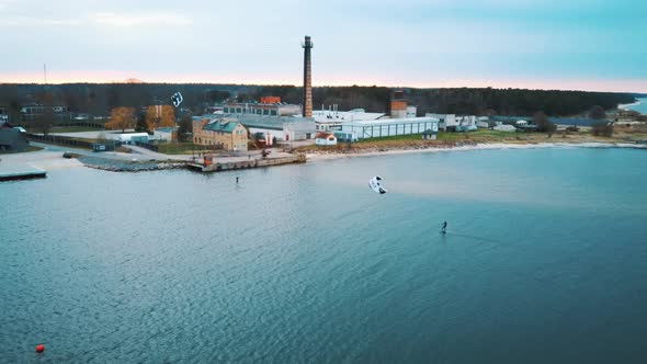 Aerial Drone View of a Corekites Kitesurfers Hydrofoiling  in Engure Port at in Baltic Sea alt