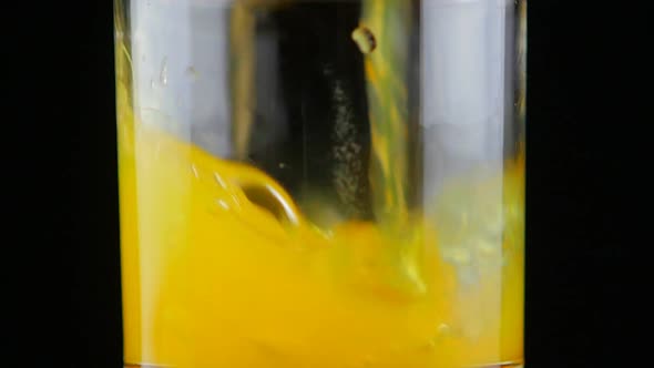 Pouring Orange Juice Soda in Glass in Slow Motion