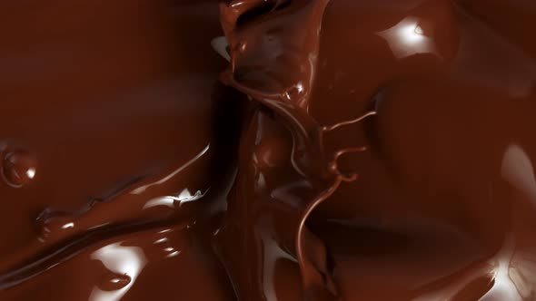 Super Slow Motion Shot of Splashing Melted Chocolate Background at 1000Fps. alt
