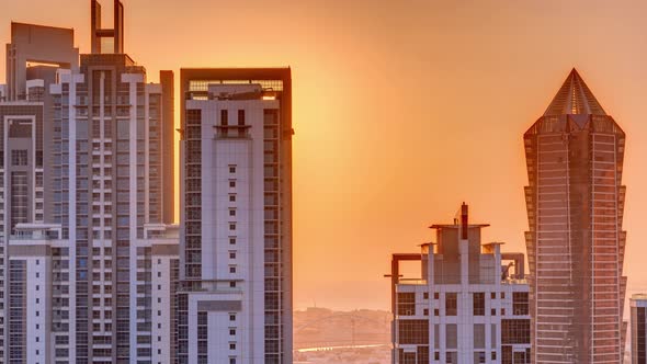Sunset Behind Modern Residential and Office Complex Aerial Timelapse at Business Bay Dubai alt