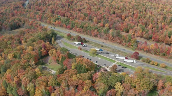 Aerial Drone Shot of US Highway Rest Stop During Peak Fall Leaf Colors