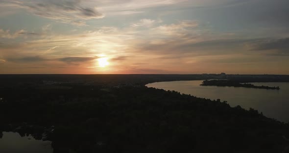 Drone Take Off During a Beautiful Sunset Overlooking the Forest and the River Ukraine. Beautiful Sky