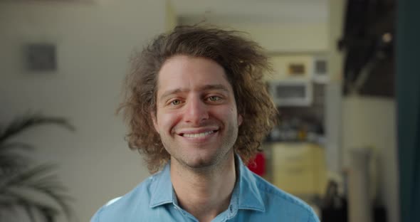 Closeup Portrait of an Attractively Curlyhaired Laughing Happy Young Man alt