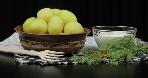 Boiled New Delicious Potato on Plate on Table Ready To Eat. Dill, Sour Cream alt