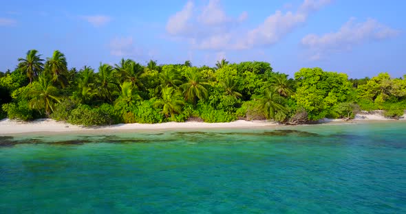 Daytime aerial island view of a white paradise beach and blue sea background in best quality 4K alt