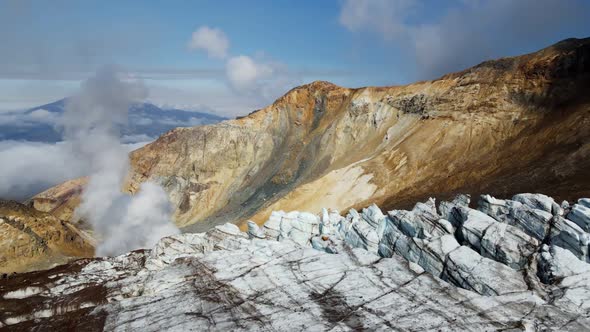 glacier and smoke in the crater of a large volcano