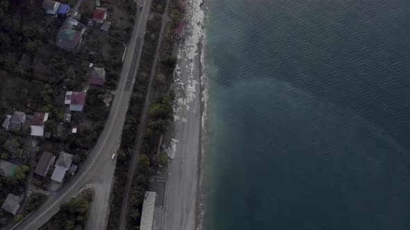 View From Above Nature Landscape with Sea Coast and Asphalt Highway at Early Morning Sunrise alt