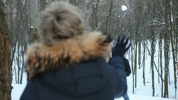 Couple Playing with Snow Boyfriend Throwing a Ball in Winter alt