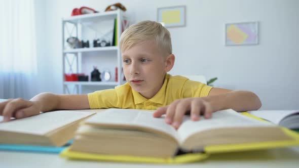 Bored Schoolboy Doing Homework and Reading Books, Upset Kid Touching Head