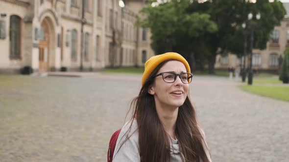 Motion View of Teens Meeting in Front of University Happily Hugging Each Other alt