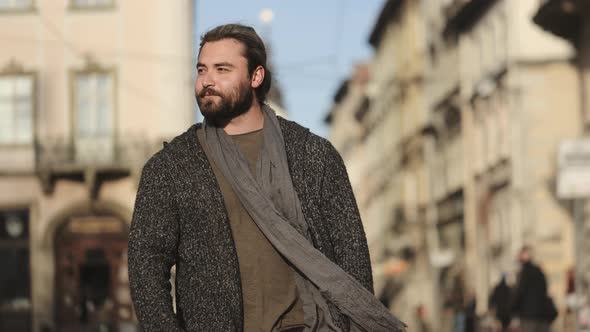 A Bearded Man is Walking Around the City alt