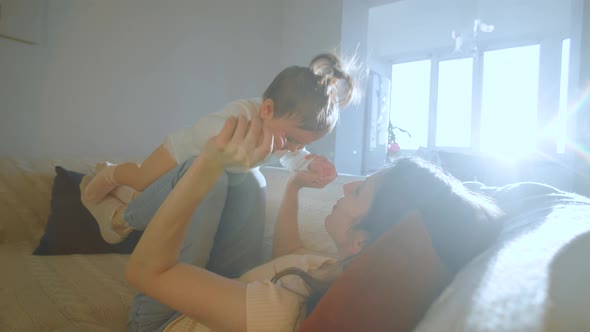 Happy Young American Mommy Playing with Cute Small Adorable Toddler Baby Daughter alt