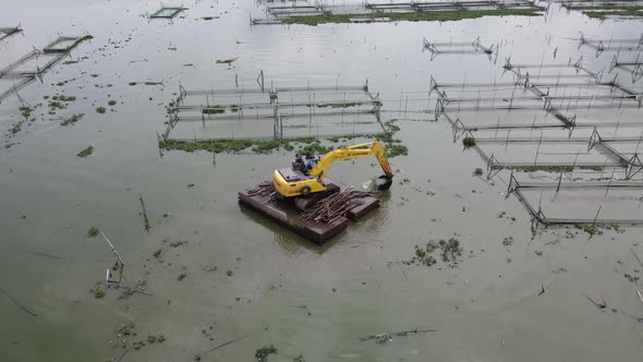 aerial view of crane in traditional floating fish pond on swamp in Indonesia alt
