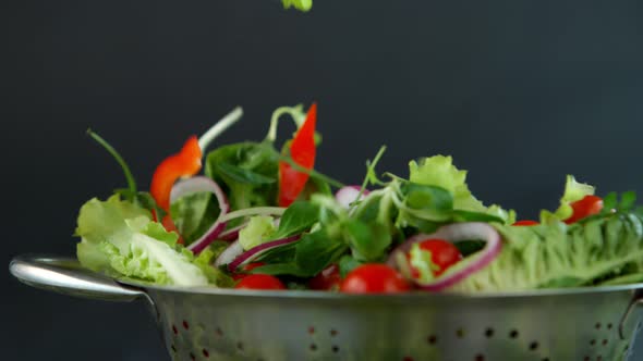 Fresh Salad Flying to Colander in Super Slow Motion alt