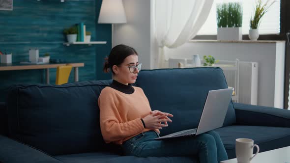 Young Person Attending Videoconference Meeting on Laptop alt