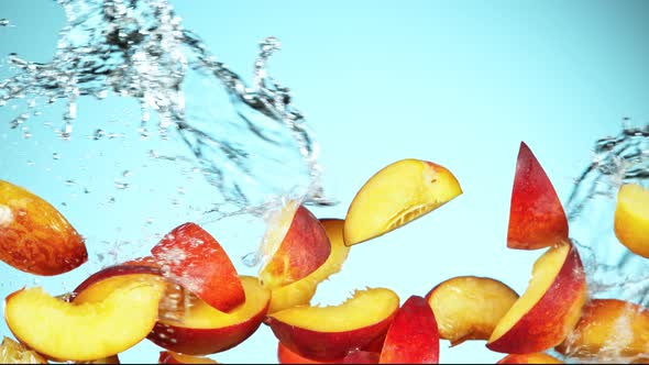 Super Slow Motion Shot of Flying Fresh Peach Slices and Water Side Splash at 1000Fps alt