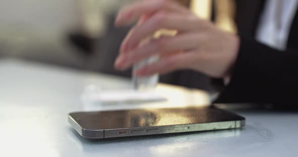 Closeup of Woman Hands Woman Cleans the Smartphone It with Antiseptic and Wipes the Process of alt
