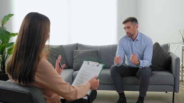 Man Patient with Mental Health Problems Talking to Therapist and Breathes Deeply alt
