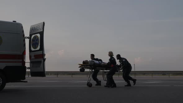 Ems Paramedics in Hurry Transporting Patient on Stretcher alt