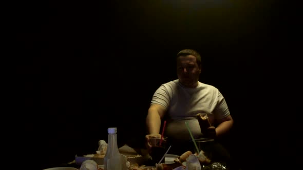 Fat Man Eating Junk Food Burgers and Hot Dogs and Watching TV, Slow Mo, Overweight alt
