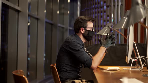 Businessman Wearing Face Mask.Man Puts On Face Mask.Remote Office Internet Online Meeting Conference alt