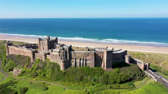 Aerial footage the famous Bamburgh Castle, a castle on the northeast coast of England