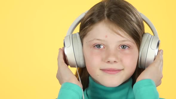Сlose-up Girl Listening To Music in Big White Headphones. Slow Motion alt