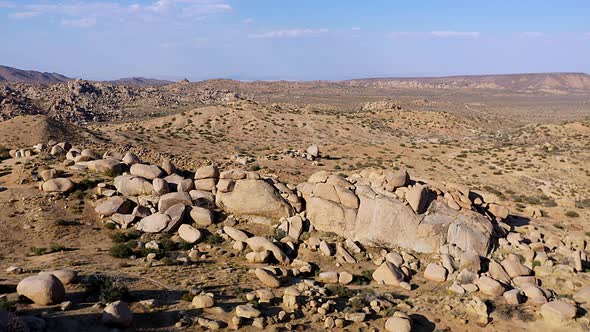 Drone shot of some really cool rocks and boulders in the sandy desert of southern California. alt