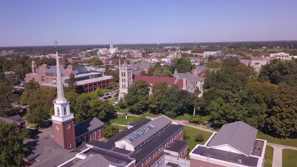 Forward aerial of buildings and trees at campus of Hope College, MI alt