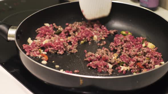 Close Up of Ground Beef Being Cook in a Non Sticky Fry Pan on an Electric Stove alt