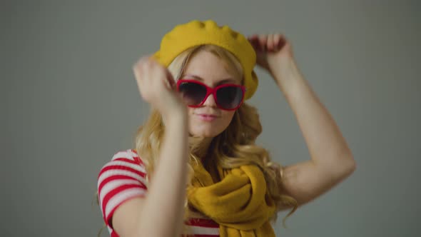 Beautiful Caucasian Woman with Sunglasses Having Fun Smiling and Dancing in Studio alt