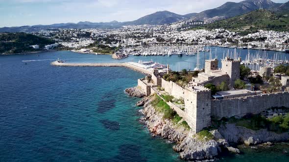 View from drone on full of yachts Bodrum harbour and ancient Kalesi castle in Mugla in Turkey alt
