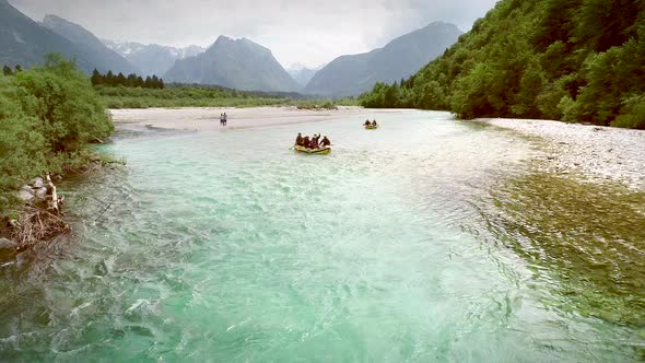 Aerial view of rafters doing rafting with clear water at Soca river, Slovenia. alt