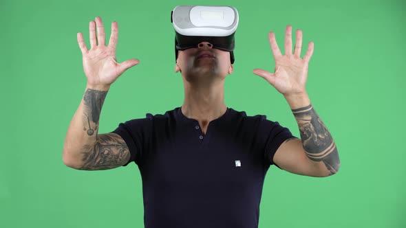 Portrait of a Handsome Young Guy with Virtual Reality Goggles. Green Screen alt