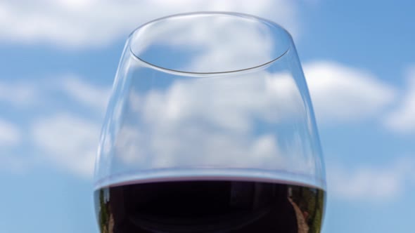 Glass of Red Wine Against Blue Sky alt