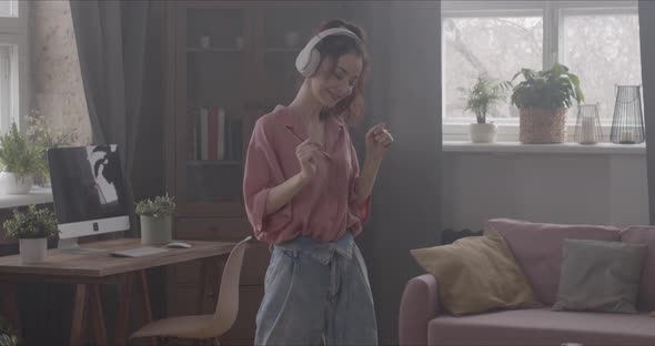 Girl Listens To Music With Headphones And Dances