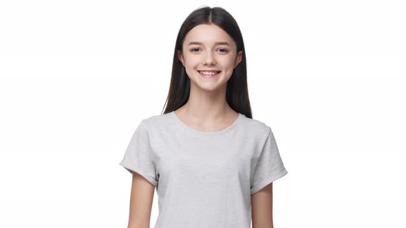 Portrait of Lopeared Pleased Woman with Long Dark Hair in Basic Tshirt Laughing Like Happy Girl alt