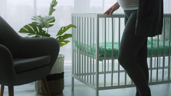 Tilt up video of pregnant woman strobing her advanced abdomen. Shot with RED helium camera in 8K   alt