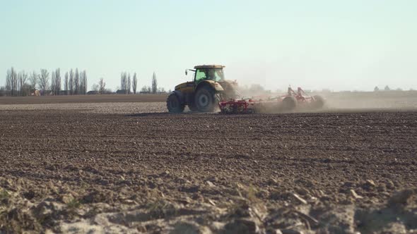 The Tractor Plows The Land In Preparation For Sowing alt